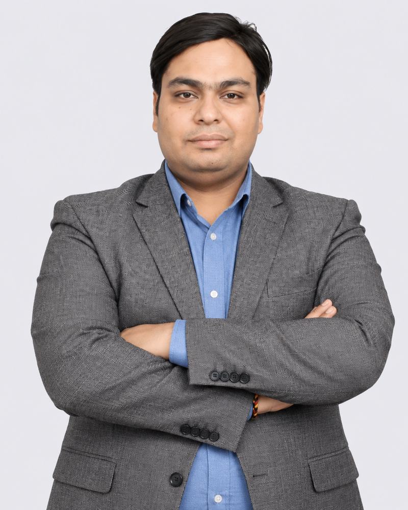 Portrait of Vaibhav Goyal, Business Analyst, wearing a grey blazer and blue shirt